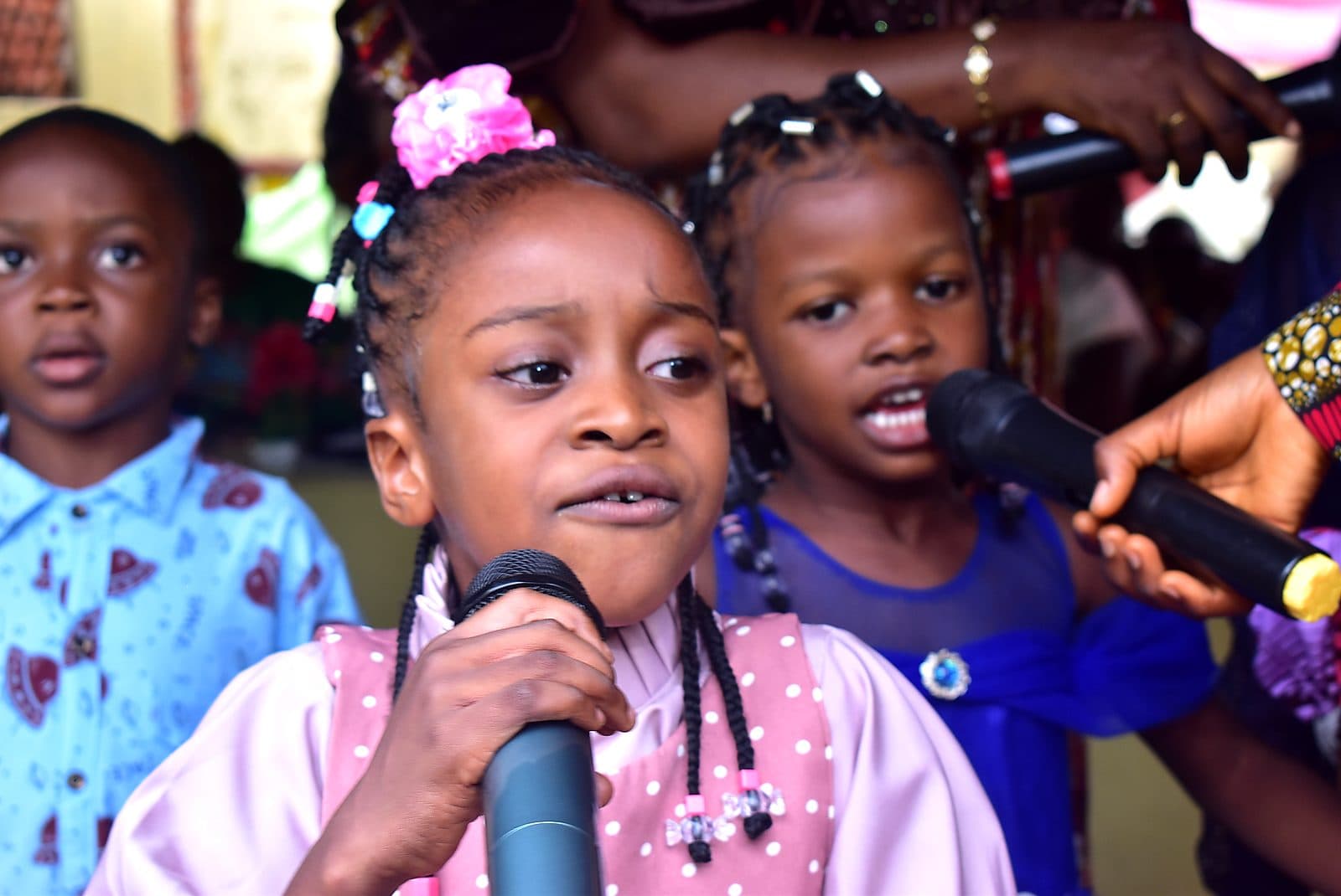 Two pupils sharing a microphone during a presentation