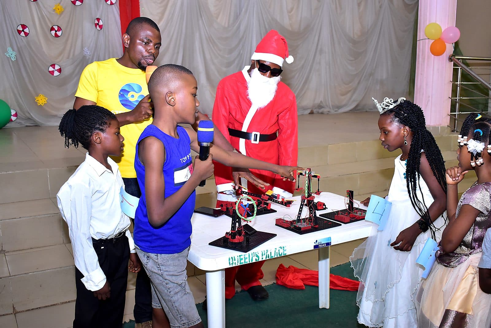 A pupil explaining his build to guests at the STEM display