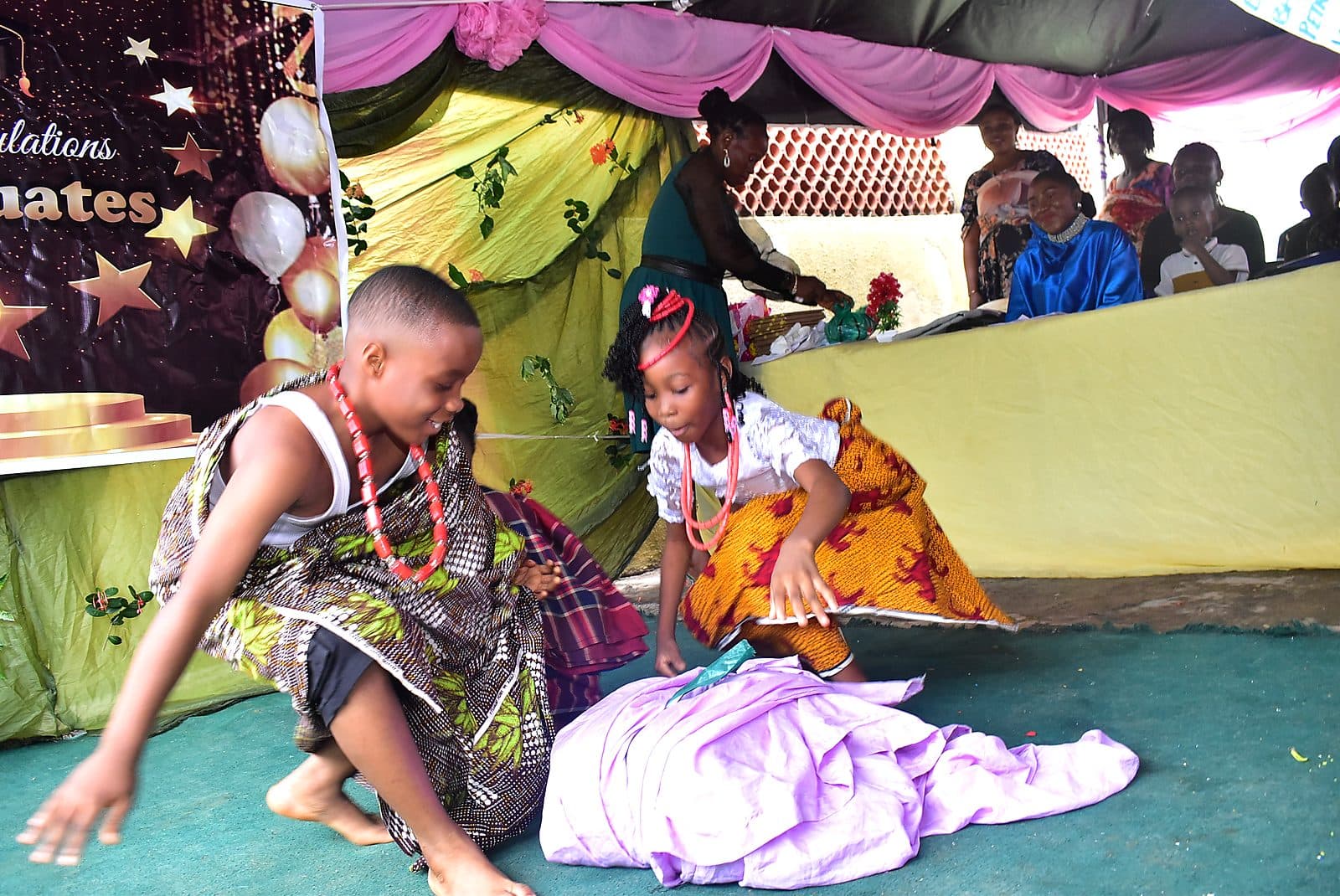 Two pupils performing a traditional dance