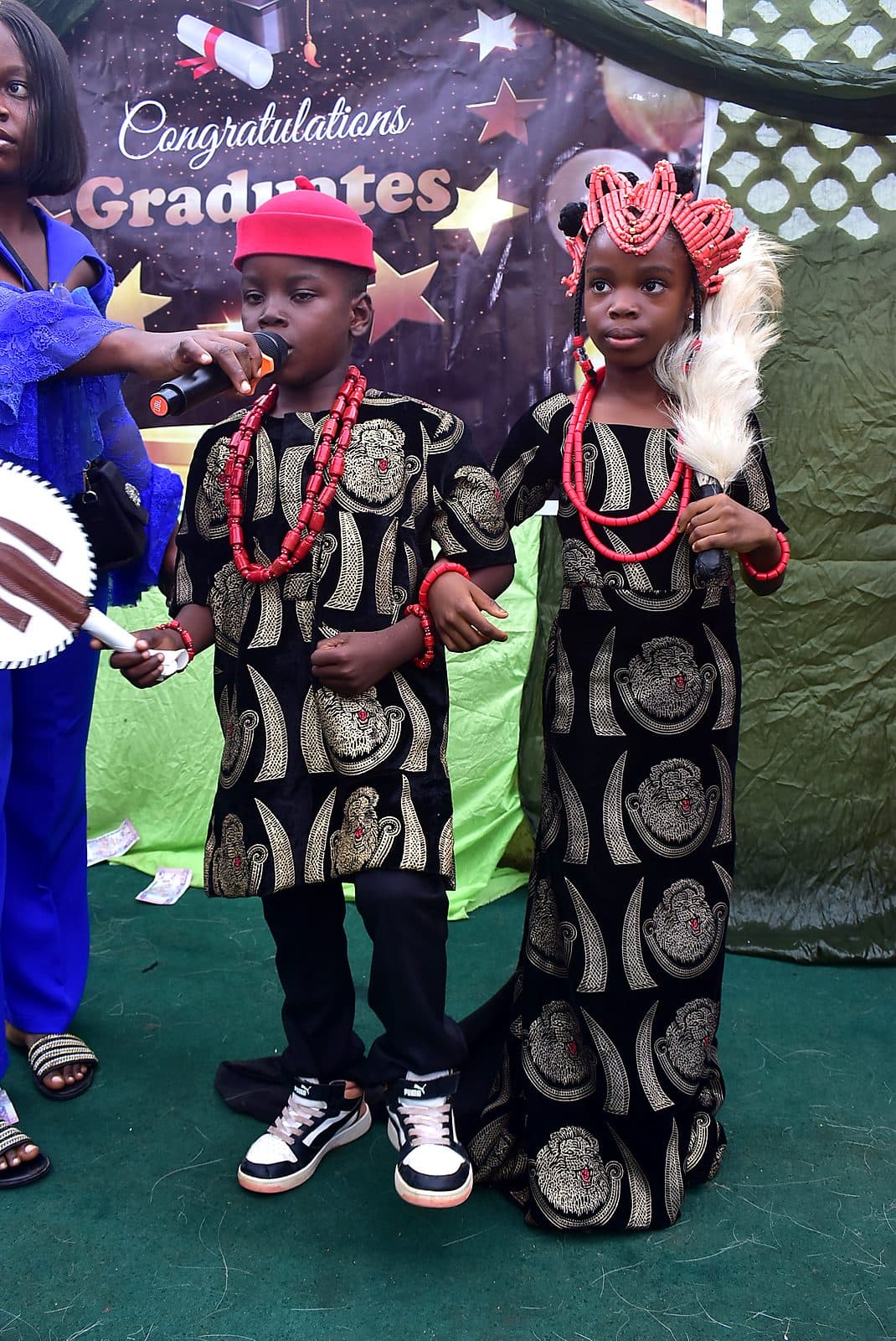 Two pupils in matching traditional dress