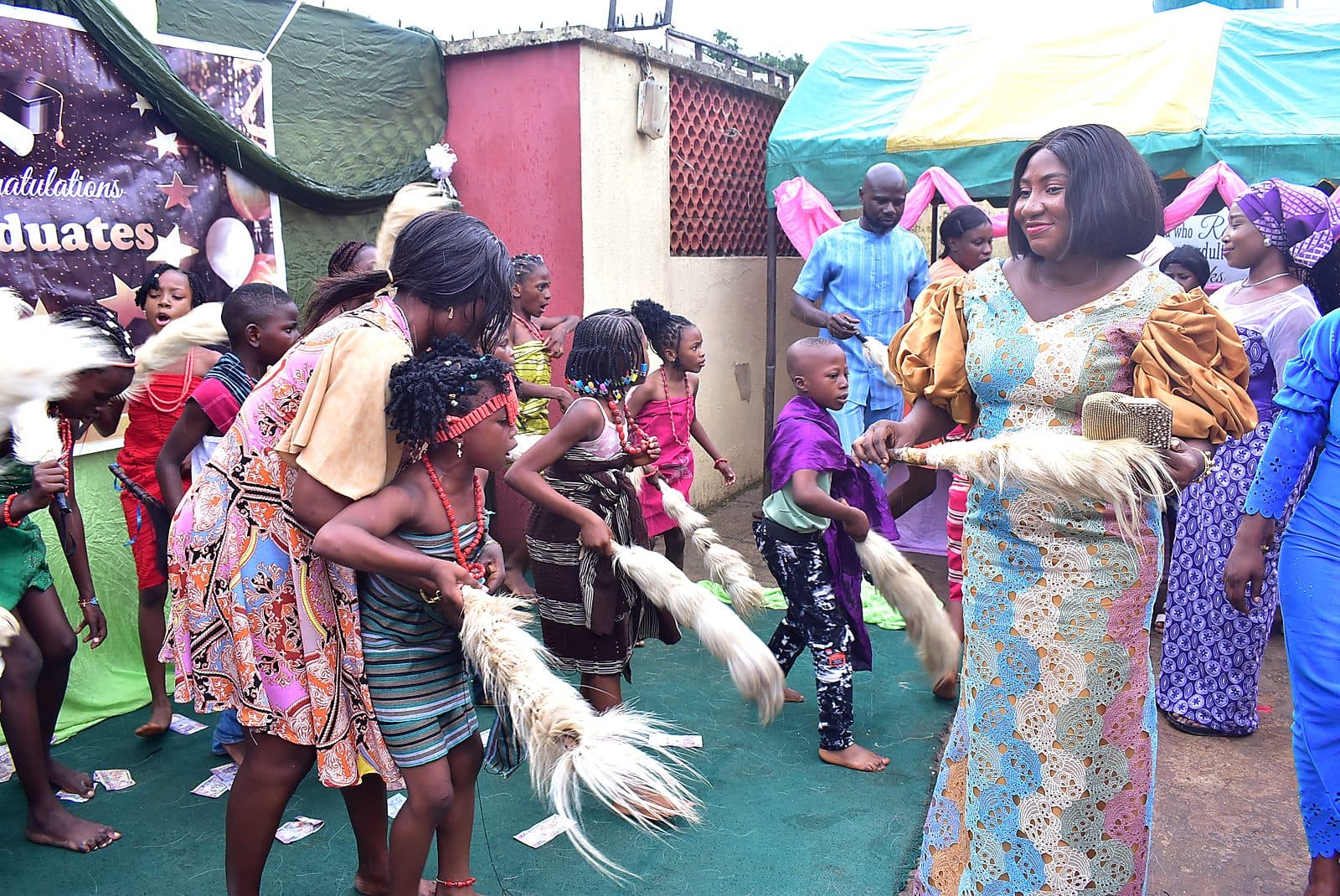 Pupils and adults dancing together during the celebration