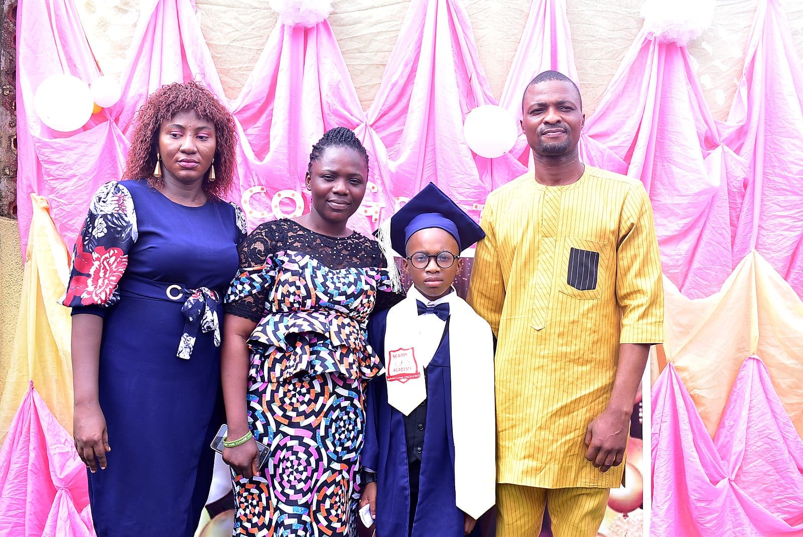 A graduate with his family after the ceremony