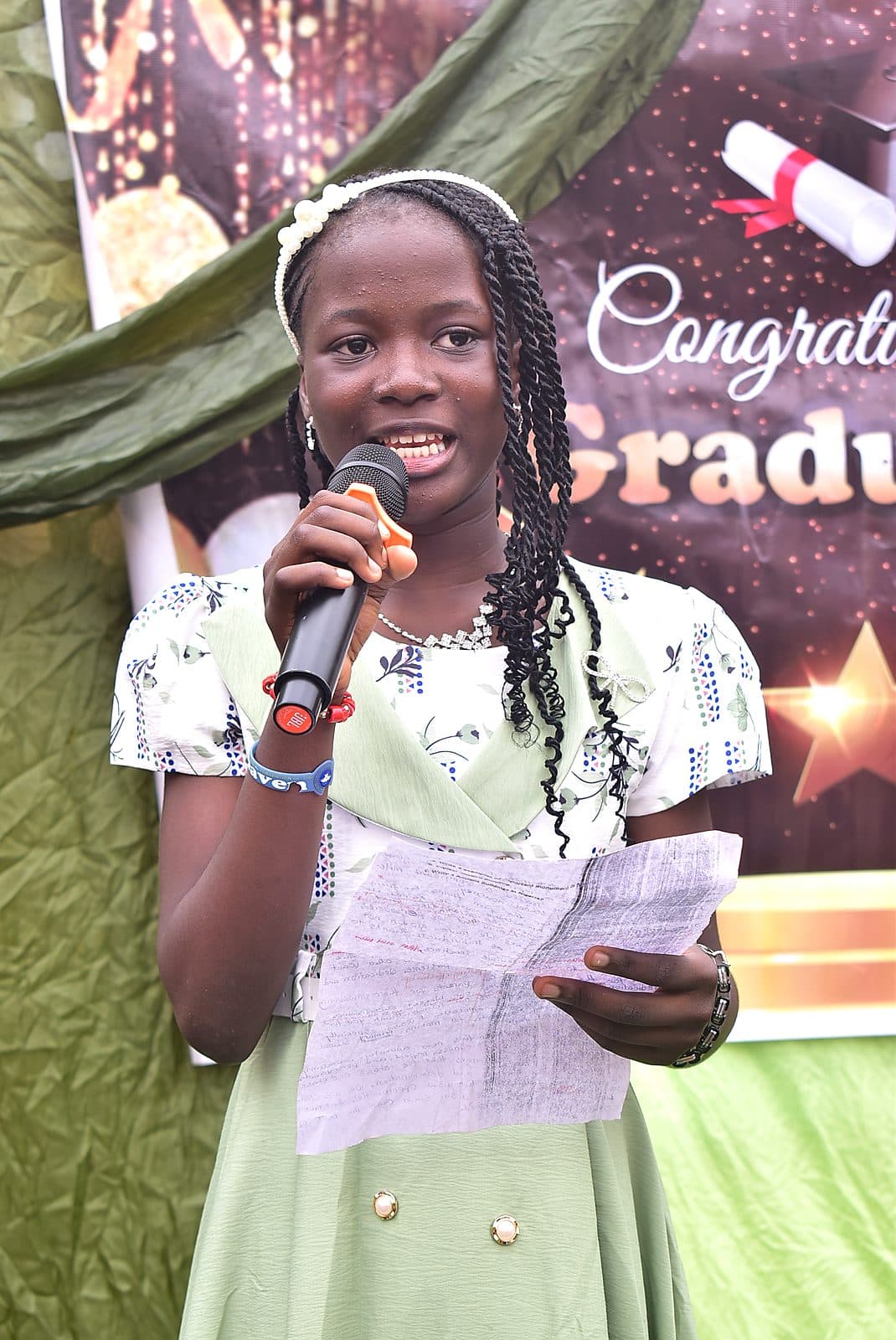 A pupil reading aloud at the microphone